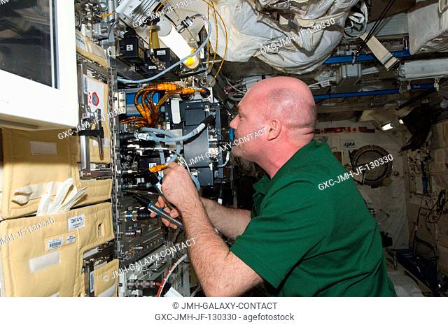 European Space Agency astronaut Andre Kuipers, Expedition 30 flight engineer, works to remove the Marangoni Surface fluid physics experiment from the Fluid...