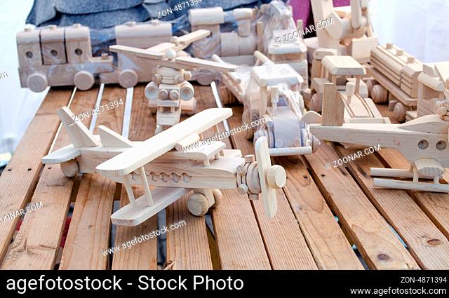 wooden handmade plane and helicopter form models toys sell in outdoor street store market fair