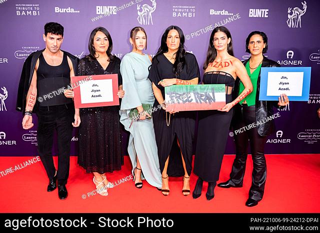 05 October 2022, Berlin: Guests carrying solidarity signs for the protests in Iran arrive at the ""Tribute to Bambi"" charity event