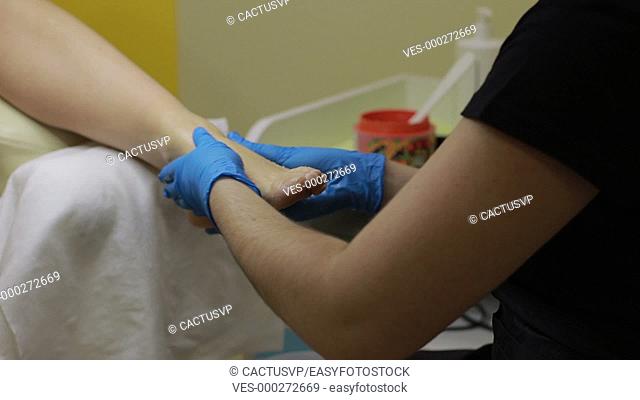 Woman's leg getting foot scrub pedicure