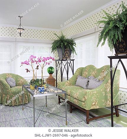 SUNROOMS: Garden theme, two tall pedestals with large ferns in cahepot pots, sheer blinds, green toile settee and chairs, zinc table with orchids