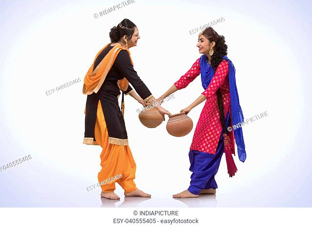 Two Women Dancing with Earthen Pot