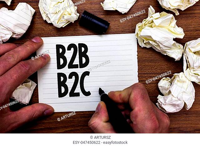 Word writing text B2B B2C. Business concept for two types for sending emails to other people Outlook accounts Man holding marker notebook page crumpled papers...