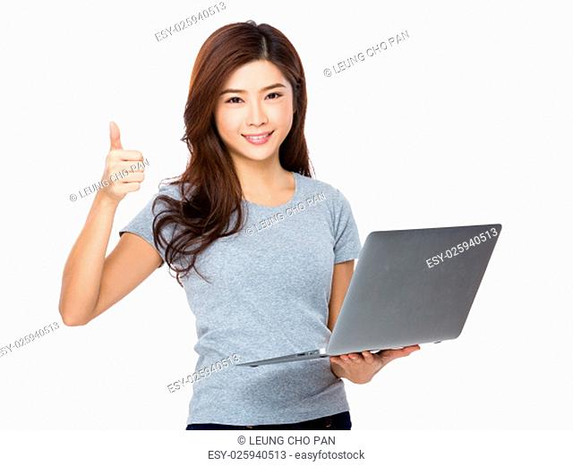 Woman use of the laptop computer and thumb up