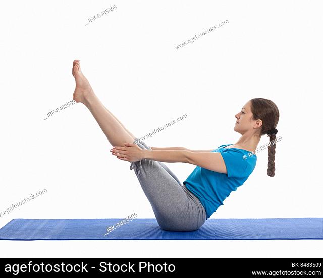 Yoga, young beautiful woman yoga instructor doing Full Boat pose asana (Paripurna navasana) exercise isolated on white background
