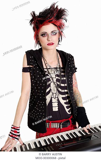 Portrait of rock woman with spiked hair and piano over white background
