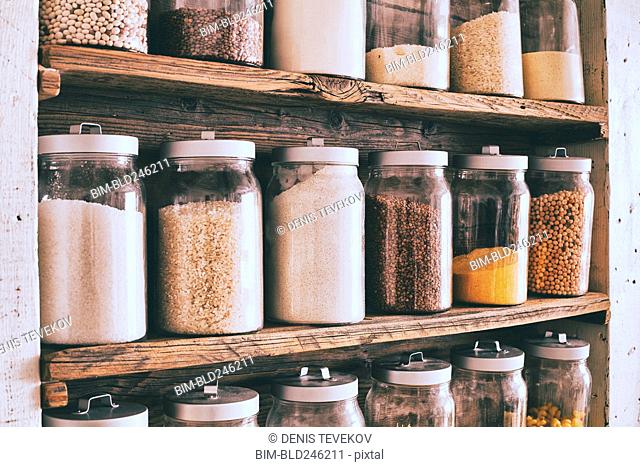 Jars of ingredients on wooden shelves