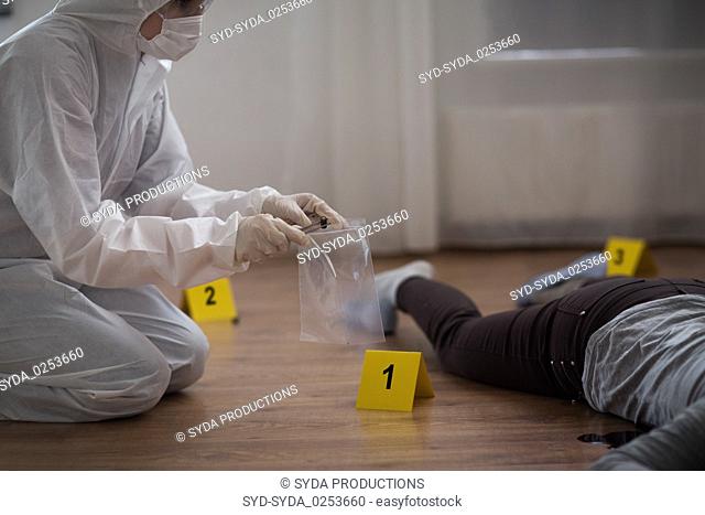 criminalist collecting crime scene evidence