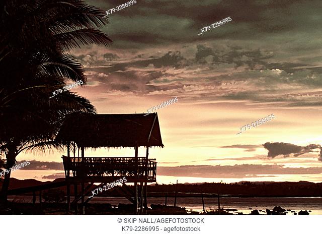 A rest house made of bamboo sits overlooking the beach on the island of Siargao in the Philippines