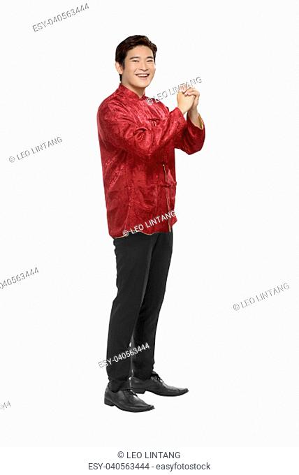 Portrait of chinese man in traditional clothes with hand gesture posing isolated over white background