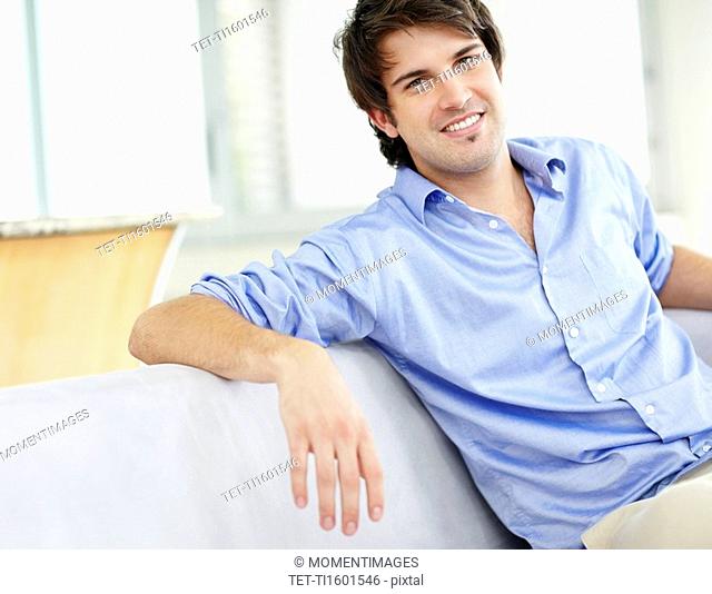Handsome man sitting on couch