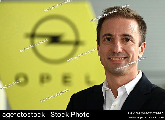 PRODUCTION - 24 February 2023, Hesse, Rüsselsheim: Florian Huettl, Managing Director of Opel Automobile GmbH, stands in front of an Opel brand logo at the...