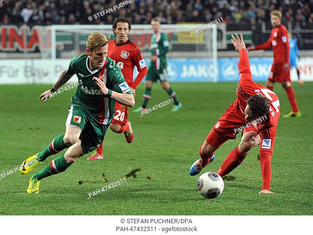 Augsburg's Andre Hahn (L) vies for the ball with Leverkusen's Sebastian Boenisch during the German Bundesliga match between FC Augsburg and Bayer 04 Leverkusen...
