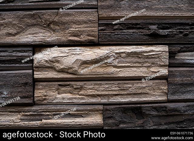 Natural stone bricks as a decoration on a wall. Natural stone wall texture. The walls are made of stones or marbles. Decoration for the walls or febces