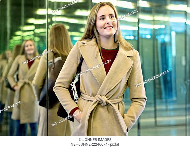Smiling woman with mirrors on background