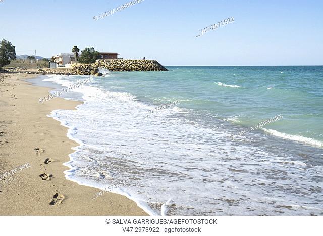Footprints in the sand of an idyllic beach in Cullera, Valencia, Spain