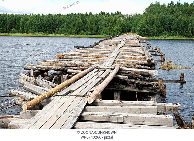 An old broken bridge on a river in Karelia