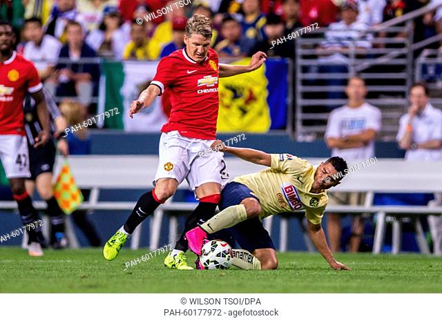 Manchester United's Bastian Schweinsteiger competes for the ball against Club America's Osvaldo Martinez during the soccer friendly match between Manchester...