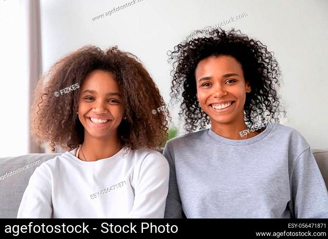 Happy african american family mother and teen daughter vloggers recording vlog, smiling black mom with teenager girl make video call looking at camera webcam...