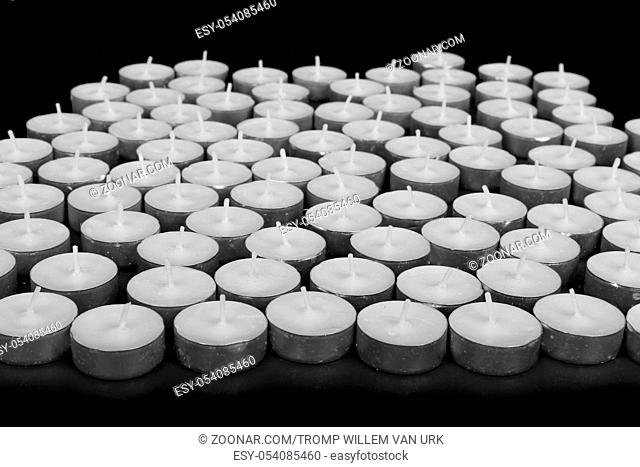 Group of white candles at a black background