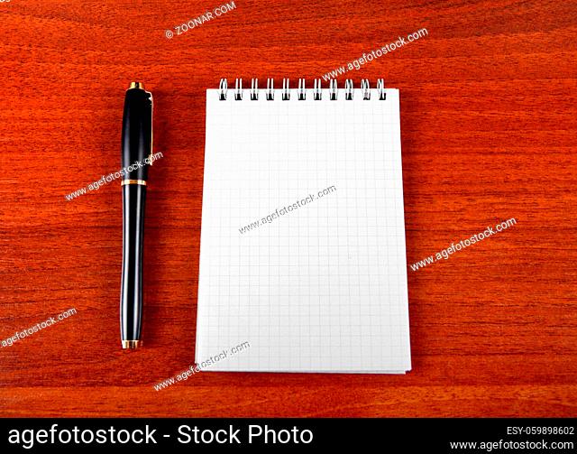 Blank Writing Pad and Pen on The Table