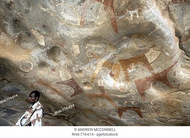 A Somaliland soldier stands guard at the 5000 year-old cave paintings in Lass Geel caves, Somaliland, northern Somalia, Africa