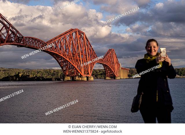 Public takes pictures during Golden Hour at North Queensferry of the Forth Bridge. Featuring: public at Forth Bridge Where: Edinburgh