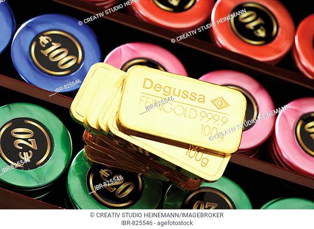 Gold bars on a roulette table with casino chips