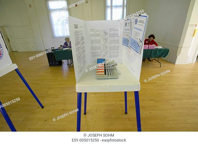Election volunteers and voting booths in a polling place, CA