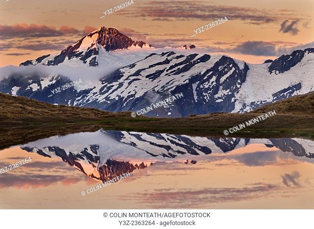 Mt Aspiring, reflection at dusk Cascade saddle tarn, Mount Aspiring National Park, Otago, New Zealand