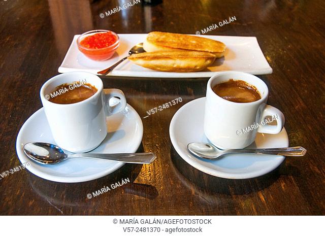 Spanish breakfast: two cups of coffee and bread with olive oil and tomato
