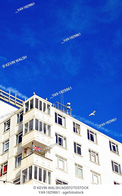 British Union Jack flag flying from balconey of apartment block