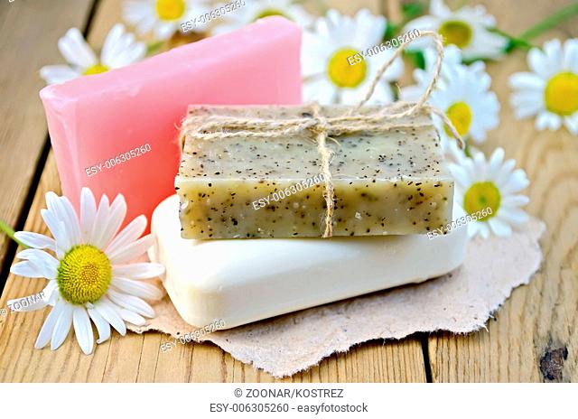 Soap with chamomile on a board