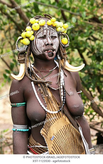 Africa, Ethiopia, Debub Omo Zone, Mursi tribesmen  A nomadic cattle herder ethnic group located in Southern Ethiopia, close to the Sudanese border  Woman with...