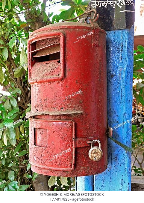 post box Mailbox, mounted on wooden pillar Chiplun, Ratnagiri, Maharashtra, India