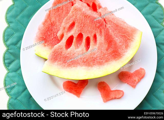 close-up on the table are two pieces of watermelon