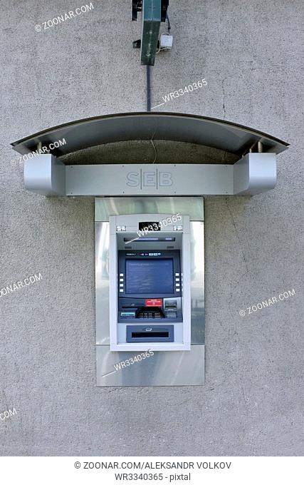 VILNIUS, LITHUANIA - MARCH 27, 2016: The street ATM of production of Diebold brand is built in a wall of SEB bank. Diebold and IBM created a general partnership...