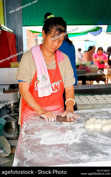 Woman making dough stick