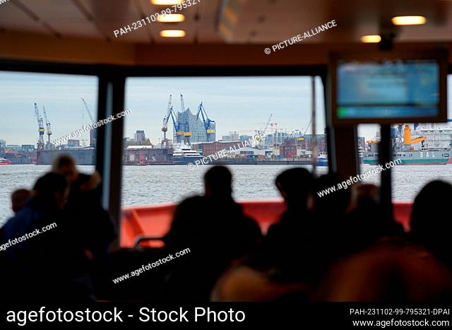 02 November 2023, Hamburg: View through the windows of a HVV harbor ferry at the Elbe Philharmonic Hall and the Blohm & Voss shipyard in the Port of Hamburg