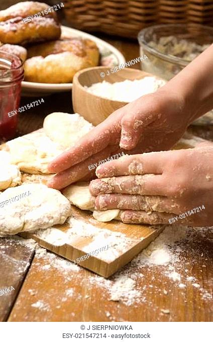Detail of hands kneading dough