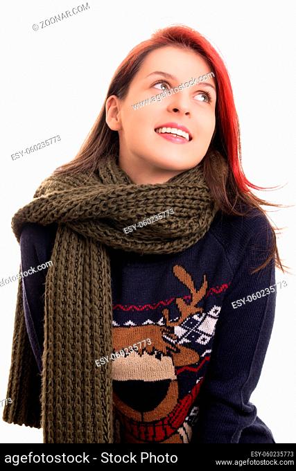 Portrait of a beautiful happy young girl in Christmas sweater and a knitted scarf, isolated on white background