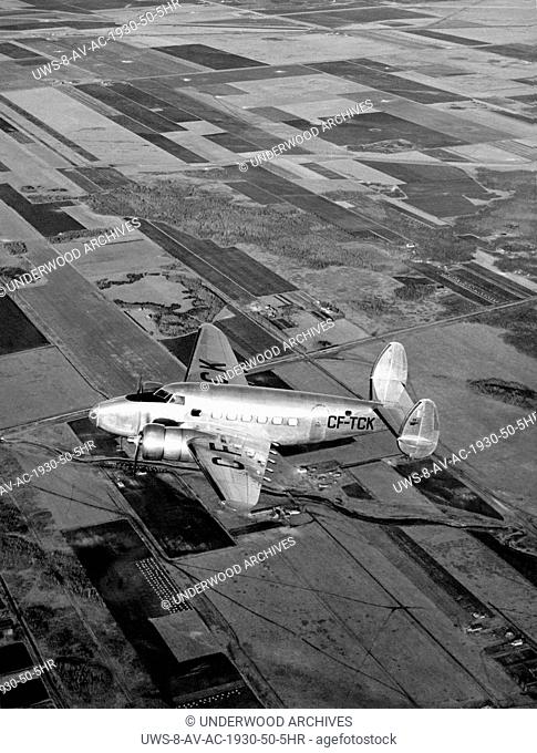 Manitoba, Canada, 1939.Trans-Canada Air Lines' new Lockheed 14H2 flying over the prairies of western Canada. It carried 10 passengers and flew between Vancouver...