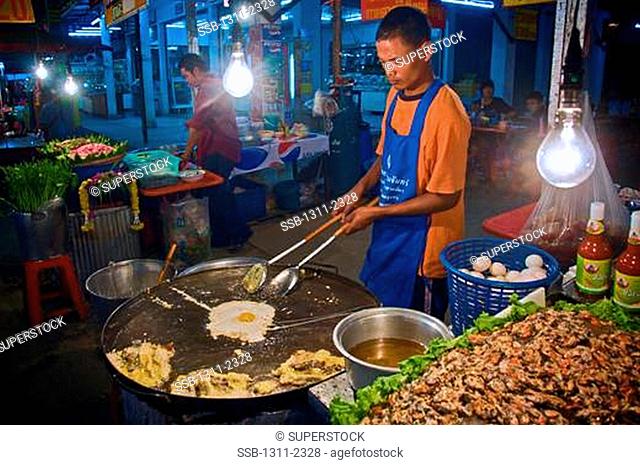 Tahi man makes a dinner staple for up country Thai people -- omlets