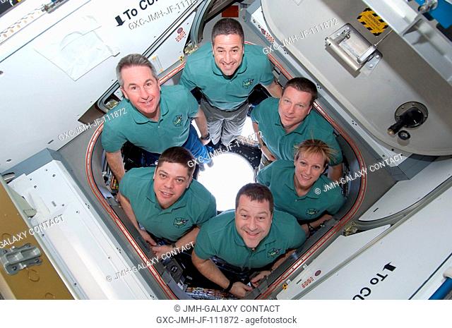 STS-130 crew members pose for a portrait in the Cupola following a joint crew news conference with the Expedition 22 crew members while space shuttle Endeavour...