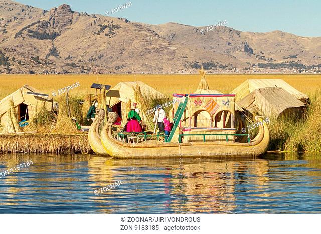 Family living on floating reed islands at Lake Titicaca Peru Bolivia