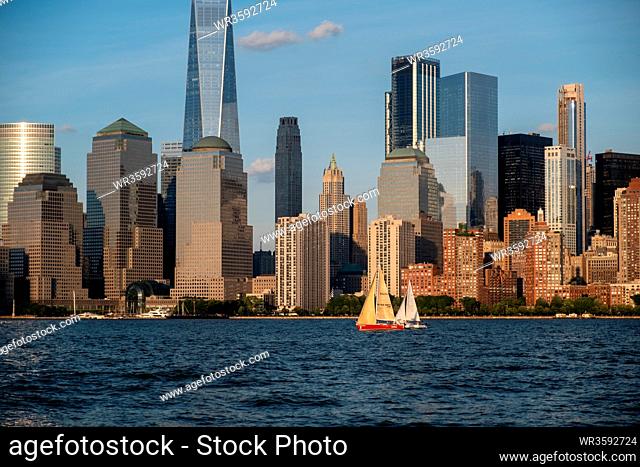 Jersey City, NJ - USA - Aug 30 2019: Lower Manhattan skyline with boat and ferry on Hudson river view from Liberty State Park in late summer