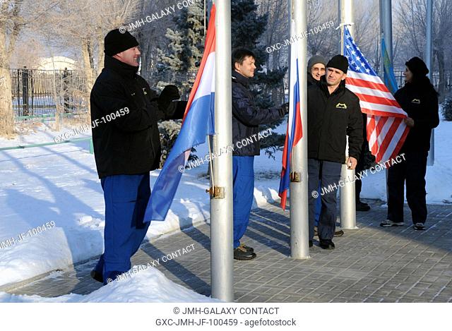At their crew quarters at the Cosmonaut Hotel in Baikonur, Kazakhstan, Expedition 30 prime and backup crew members raise the flags of the Netherlands