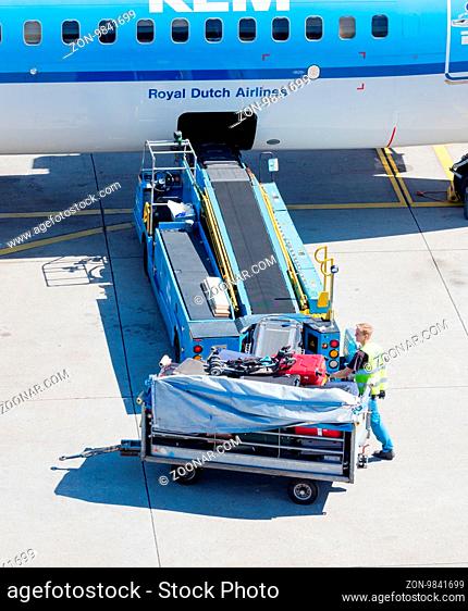 AMSTERDAM, NETHERLANDS - AUGUST 17, 2016: Loading luggage in airplane at Amsterdam Schiphol airport, Netherlands on August 17, 2016
