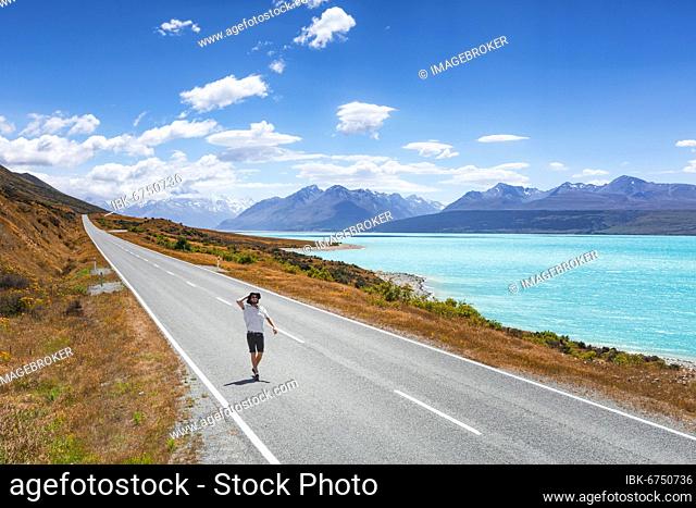 Guy on a road, Lake Pukaki, Mount Cook, Canterbury region, Mackenzie District, South Island, New Zealand, Oceania