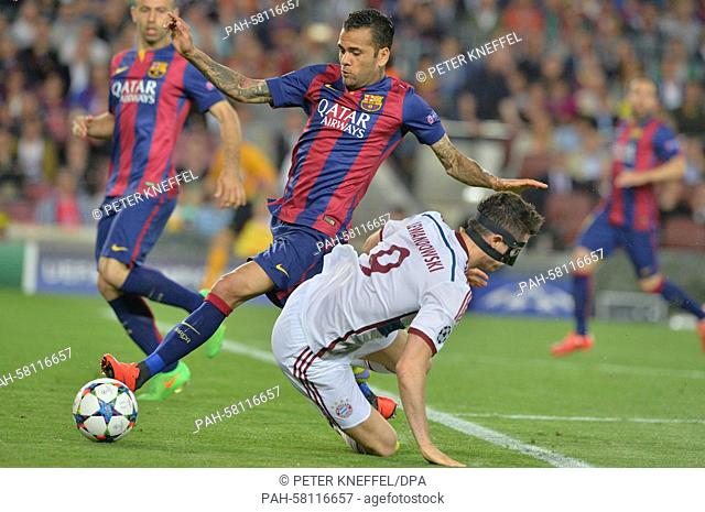 Barcelona's Dani Alves (L) and Munich's Robert Lewandowski (R) vie for the ball during the UEFA Champions League semi-final first leg soccer match betweeen...